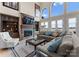 Spacious living room with a fireplace, built-in shelving, and large windows offering lake views at 3988 Channel Point Ln, Denver, NC 28037