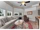 Cozy living room filled with natural light, wood floors, comfortable seating, and ceiling fan at 3988 Channel Point Ln, Denver, NC 28037