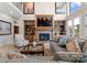 Elegant living room features a fireplace, built-in shelving, and tall windows at 3988 Channel Point Ln, Denver, NC 28037