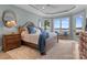 Tranquil bedroom featuring lake views, tray ceiling, and comfortable furnishings at 3988 Channel Point Ln, Denver, NC 28037
