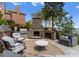 Outdoor living area with a stone fireplace, built-in grill, and comfortable seating at 3988 Channel Point Ln, Denver, NC 28037