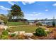 Backyard putting green with waterfront views and manicured landscaping at 3988 Channel Point Ln, Denver, NC 28037
