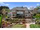 Expansive backyard with stone terracing, putting green, and an outdoor living area, perfect for entertaining at 3988 Channel Point Ln, Denver, NC 28037