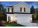 Beautiful exterior view of a bright two-story home with a two car garage and newly installed landscaping at 4325 Summit Woods Dr, Charlotte, NC 28216