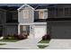 Charming two-story townhome featuring a modern design, white garage door, and low maintenance landscaping at 4325 Summit Woods Dr, Charlotte, NC 28216