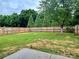 Large fenced backyard featuring green grass and privacy landscaping at 4418 Palustris Ct, Charlotte, NC 28269