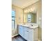 Bright bathroom featuring double sink vanity with white cabinets, large mirror, and modern lighting at 4418 Palustris Ct, Charlotte, NC 28269