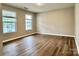 Bright bedroom with wood floors, two windows, and neutral walls creating a cozy atmosphere at 4418 Palustris Ct, Charlotte, NC 28269