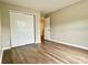 Bedroom featuring wood-look flooring and a double-door closet at 4418 Palustris Ct, Charlotte, NC 28269