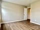 A clean, vacant bedroom with wood-look flooring and neutral paint at 4418 Palustris Ct, Charlotte, NC 28269