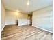 Bonus room featuring neutral walls and wood-look floors, with a partial view of an adjacent room at 4418 Palustris Ct, Charlotte, NC 28269