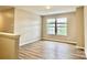 Bonus room with wood-look flooring and bright natural light from two windows at 4418 Palustris Ct, Charlotte, NC 28269
