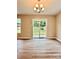 Bright dining area with new floors overlooking a backyard and patio through sliding glass doors at 4418 Palustris Ct, Charlotte, NC 28269