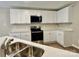 Kitchen with stainless-steel appliances and white quartz counters and cabinets at 4418 Palustris Ct, Charlotte, NC 28269