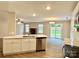 Open kitchen overlooking the living area with a stone fireplace and a sliding glass door to the backyard at 4418 Palustris Ct, Charlotte, NC 28269