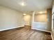 Spacious living area with wood flooring, neutral walls, and open space for versatile furniture arrangements at 4418 Palustris Ct, Charlotte, NC 28269
