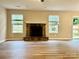 Bright living area with wood floors, a stone fireplace, and ample natural light creating a welcoming space at 4418 Palustris Ct, Charlotte, NC 28269