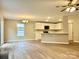 Open-concept living area flows into a modern kitchen with white cabinets and stainless-steel appliances at 4418 Palustris Ct, Charlotte, NC 28269