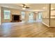 Open living room with wood floors, large stone fireplace, and sliding glass doors leading to the backyard at 4418 Palustris Ct, Charlotte, NC 28269