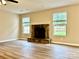 Comfortable living room featuring a stone fireplace, wood floors, and bright windows for a cozy ambiance at 4418 Palustris Ct, Charlotte, NC 28269