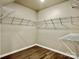 Walk-in closet with wire shelving and wood-look flooring at 4418 Palustris Ct, Charlotte, NC 28269