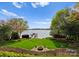Expansive backyard with a lush lawn, fire pit, and scenic views of the lake at 4628 Sierra View Dr, Denver, NC 28037