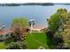 Stunning aerial view showcasing the lush backyard leading to a private beach and boat dock on the lake at 4628 Sierra View Dr, Denver, NC 28037