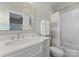 Modern bathroom featuring a sleek vanity with a quartz countertop and a shower-tub combination at 4628 Sierra View Dr, Denver, NC 28037
