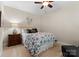 Cozy bedroom featuring a floral patterned comforter, a ceiling fan, and neutral decor at 4628 Sierra View Dr, Denver, NC 28037