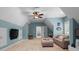 A bonus room with blue walls, built in seating, and a ceiling fan provide a great flex space at 4628 Sierra View Dr, Denver, NC 28037