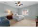 Bright bedroom with plush carpeting, a large window with blinds, and a comfortable seating area at 4628 Sierra View Dr, Denver, NC 28037
