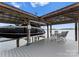 View of the covered boat dock featuring a boat lift and comfortable seating area at 4628 Sierra View Dr, Denver, NC 28037