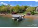 Scenic shot of a private boat dock on the lake surrounded by lush greenery and colorful landscaping at 4628 Sierra View Dr, Denver, NC 28037