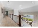 Bright hallway with open staircase offers views to the lake and sitting area below at 4628 Sierra View Dr, Denver, NC 28037