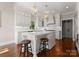 Bright kitchen with white cabinets, an island with seating, and wooden floors at 4628 Sierra View Dr, Denver, NC 28037