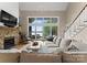 Spacious living room features a stone fireplace, large windows, and scenic lake views at 4628 Sierra View Dr, Denver, NC 28037