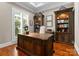 Spacious home office with custom built-in bookshelves, hardwood floors, and a large wooden executive desk at 4628 Sierra View Dr, Denver, NC 28037