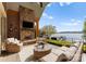 Inviting outdoor patio with stone fireplace, lounge seating, and picturesque lake views at 4628 Sierra View Dr, Denver, NC 28037