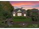An inviting brick home with a cozy patio, fire pit, and lush landscaping, perfect for outdoor gatherings at 4628 Sierra View Dr, Denver, NC 28037
