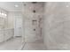 Close-up of tiled shower with glass door, mosaic tile accents, and dual shower heads at 4628 Sierra View Dr, Denver, NC 28037