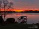 Serene waterfront view at sunset, featuring a private boat dock and tranquil lake waters at 4628 Sierra View Dr, Denver, NC 28037