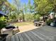 Wooden deck features wicker seating, a grill, and a view of the backyard at 4823 Antioch Church Rd, Weddington, NC 28104
