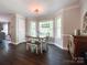 Dining area features hardwood floors, large windows, and neutral paint providing a comfortable ambiance at 4823 Antioch Church Rd, Weddington, NC 28104