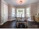 Dining area features hardwood floors, large windows, neutral paint providing a comfortable ambiance at 4823 Antioch Church Rd, Weddington, NC 28104