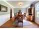 Dining room features hardwood floors, neutral paint, crown molding, a modern light fixture, and ample natural light at 4823 Antioch Church Rd, Weddington, NC 28104