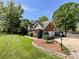 Charming brick home with an attached garage, long driveway, and a beautifully landscaped yard with mature trees at 4823 Antioch Church Rd, Weddington, NC 28104