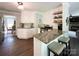 Bright kitchen featuring granite countertops, stainless steel appliances, a breakfast bar, and hardwood floors at 4823 Antioch Church Rd, Weddington, NC 28104