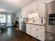Bright kitchen with white cabinets, granite countertops, stainless steel appliances, and hardwood floors at 4823 Antioch Church Rd, Weddington, NC 28104