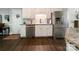 Well-lit kitchen features white cabinets, modern appliances, and sleek, dark wood flooring at 4823 Antioch Church Rd, Weddington, NC 28104
