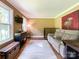 Cozy living room with a plush sofa, neutral rug, and natural light from the windows at 4823 Antioch Church Rd, Weddington, NC 28104